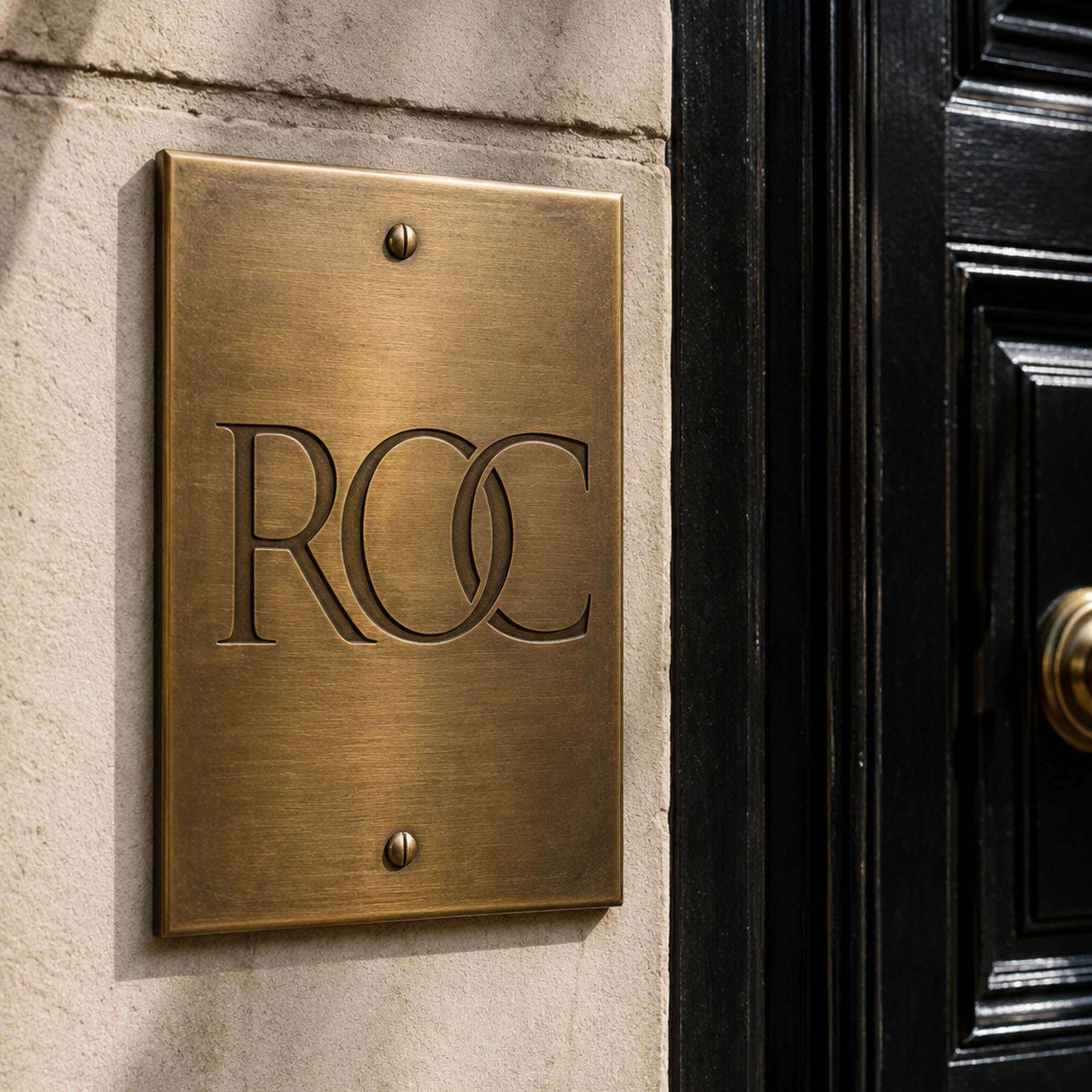 ROC Invest brand identity, interlocking ROC monogram in champagne on navy
